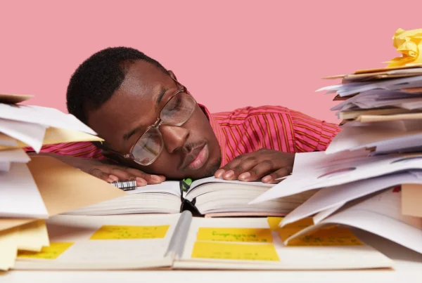 Office worker asleep at desk symbolising a website that isn’t doing its job.
